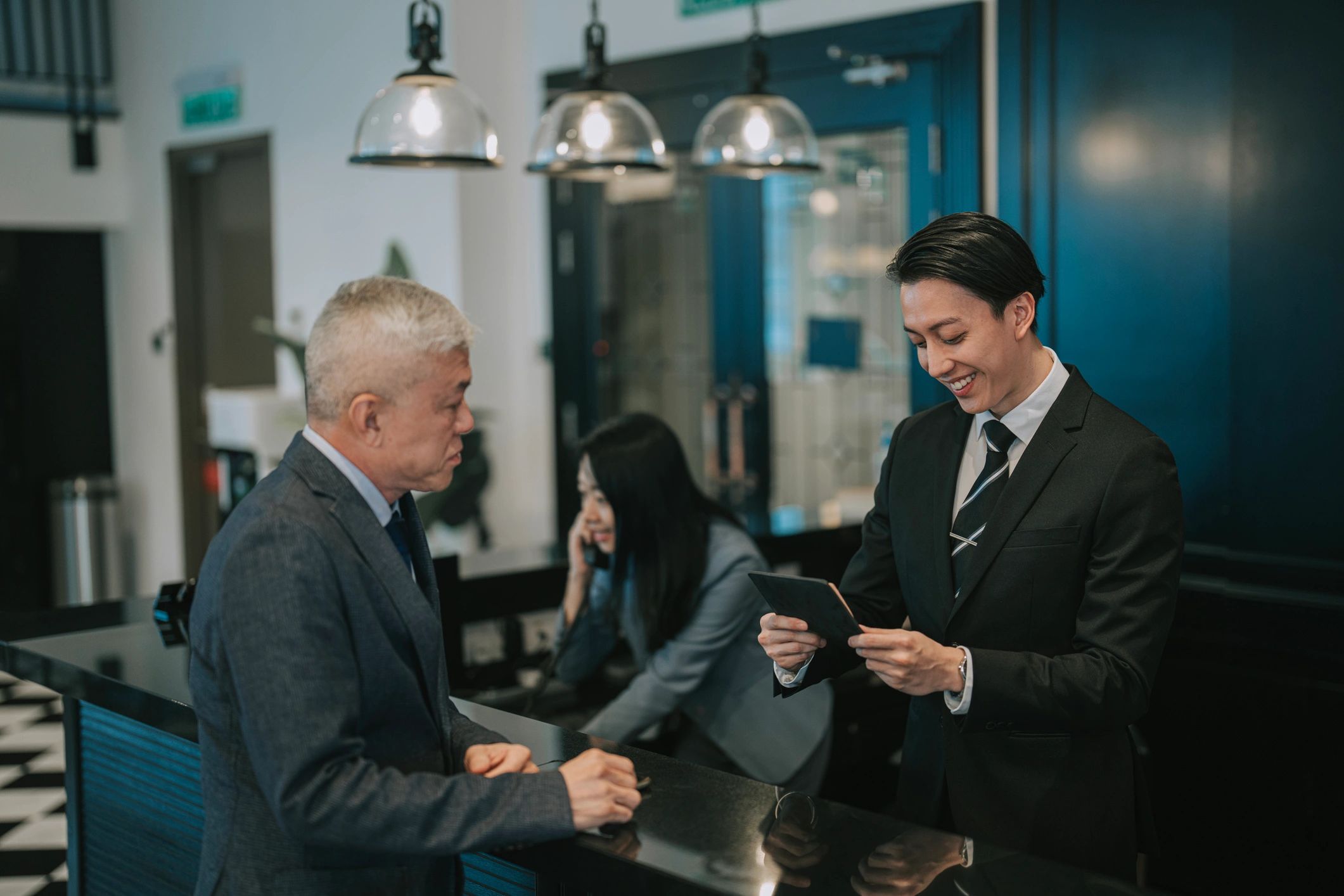 Hotel reception team assisting guests