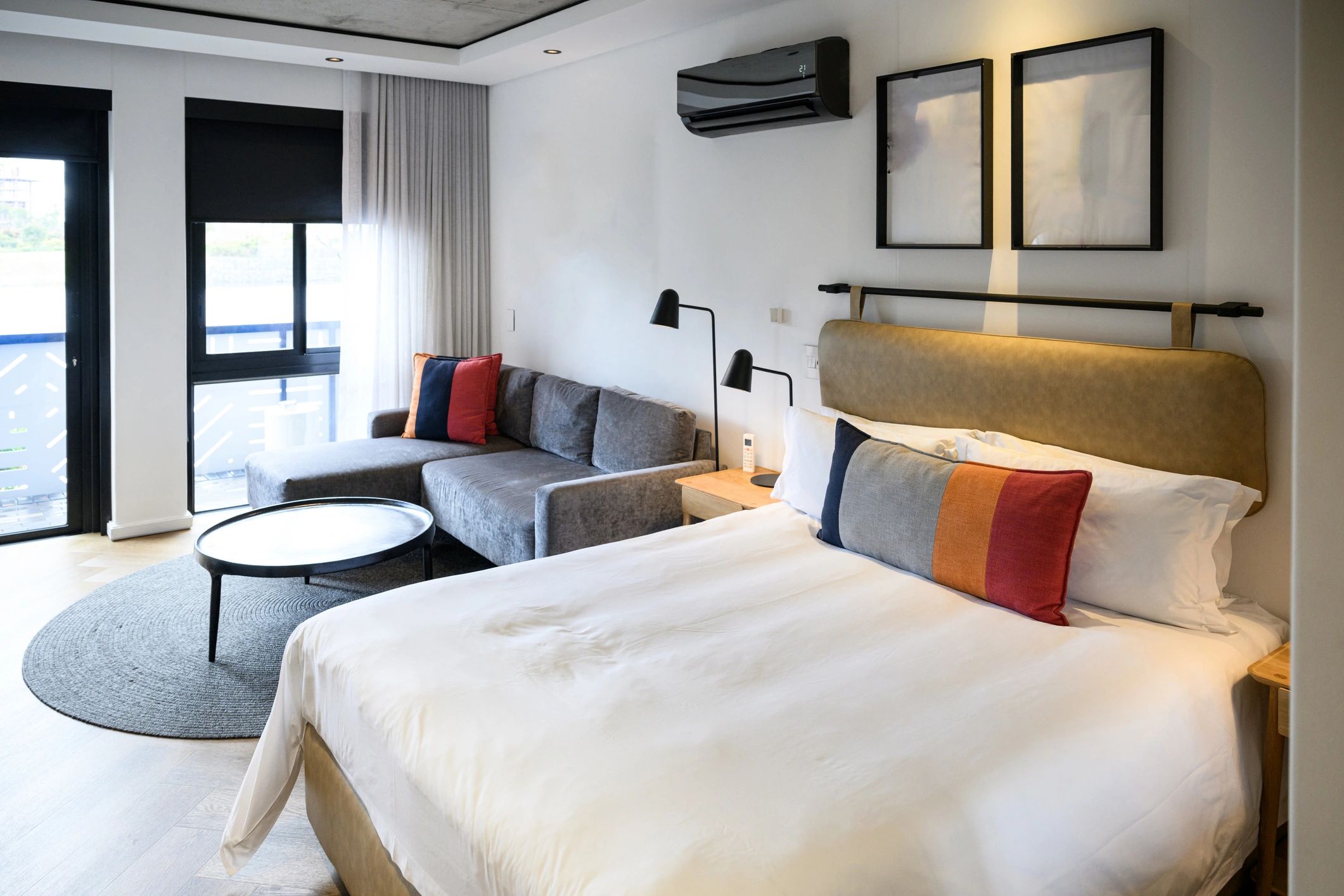 Contemporary hotel room interior with warm tones and a comfortable king bed
