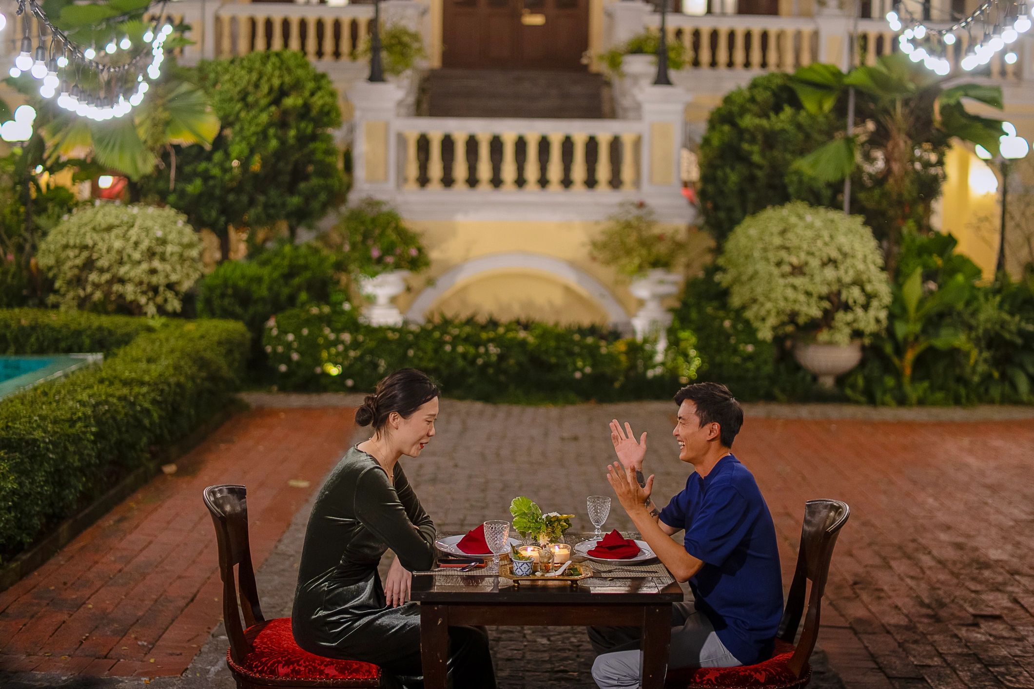 Couple dining in the evening at a luxury hotel garden