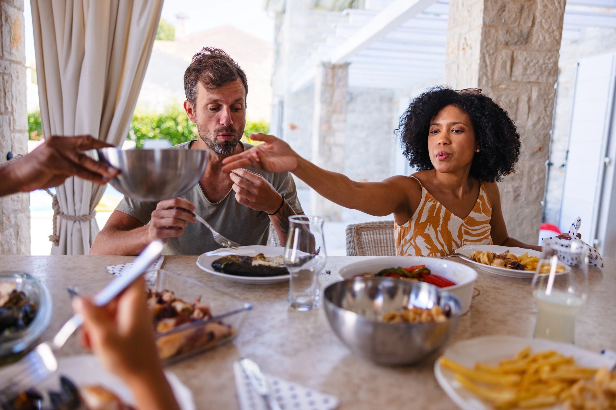 Multigenerational family enjoying outdoor lunch together
